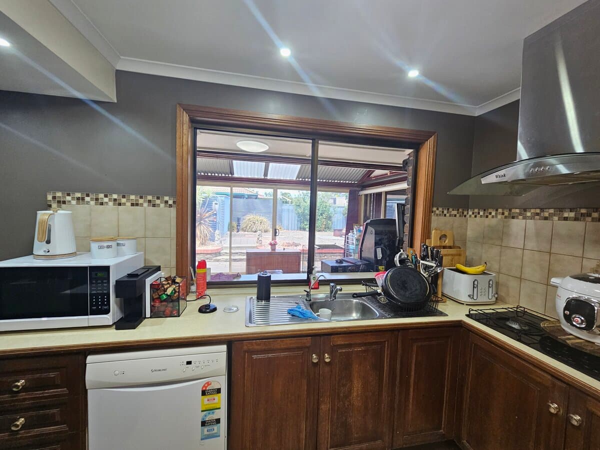 Dated dark wood kitchen before renovation at Blakeview